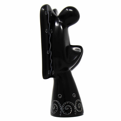 Black soapstone angel figurine showing etched wing patterns