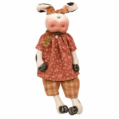 Mootilda primitive cow doll with canvas body, black painted spots, rustic country clothing, and long dangling legs displayed on a shelf