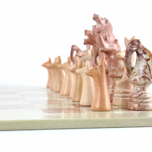 Chess pieces carved from soapstone in Kenya, featuring a satin-finished board and distinctive animal designs.