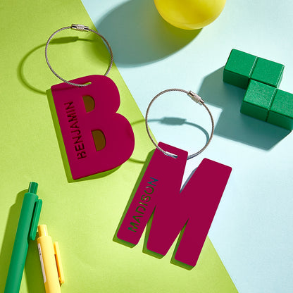 A close-up of the letter B and M in red, showcasing their 3D printed design.