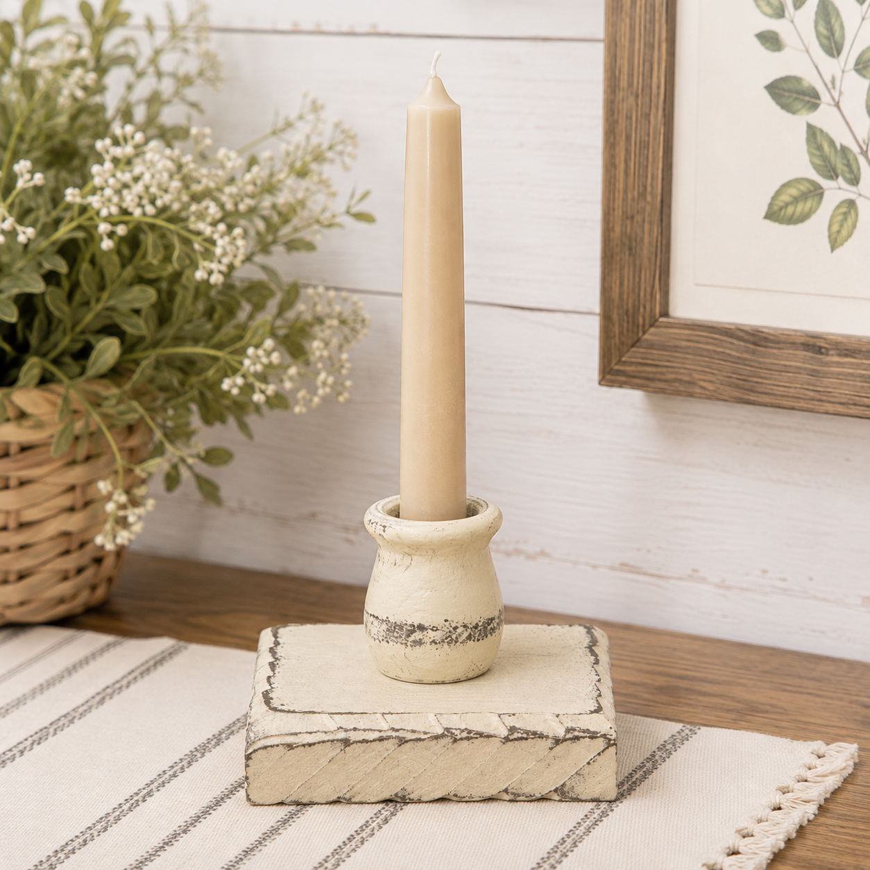Distressed buttermilk cream wooden taper candle holder with a low square base and aged painted finish.
