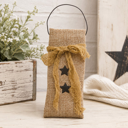 Primitive burlap hanging bag with black star design, tea-dyed cheesecloth ribbon, and black wire hanger for rustic farmhouse decor