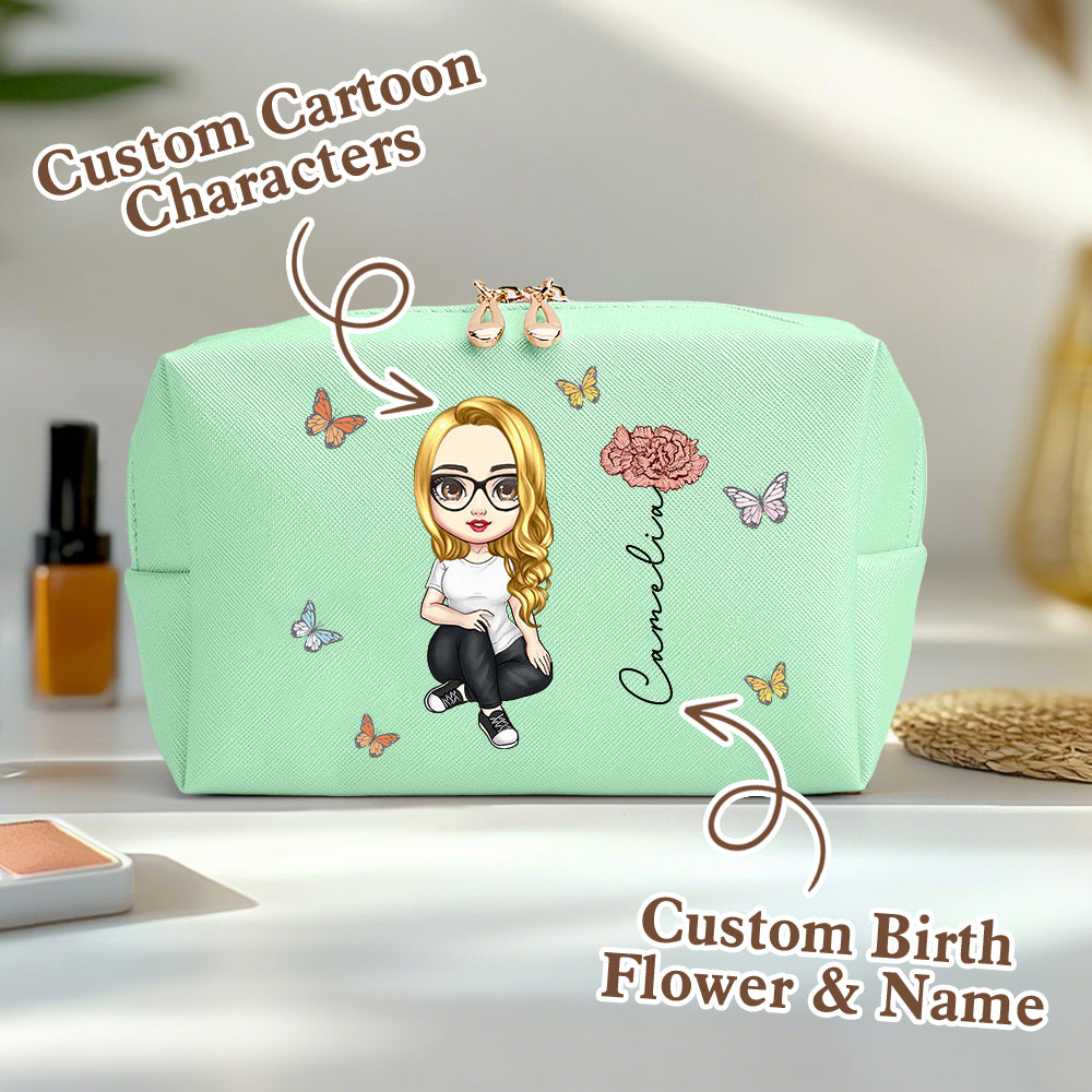 A green personalized makeup bag on a table, featuring a custom cartoon character, birth flower, and name, with an overlay saying custom cartoon characters and custom birth flower and name.