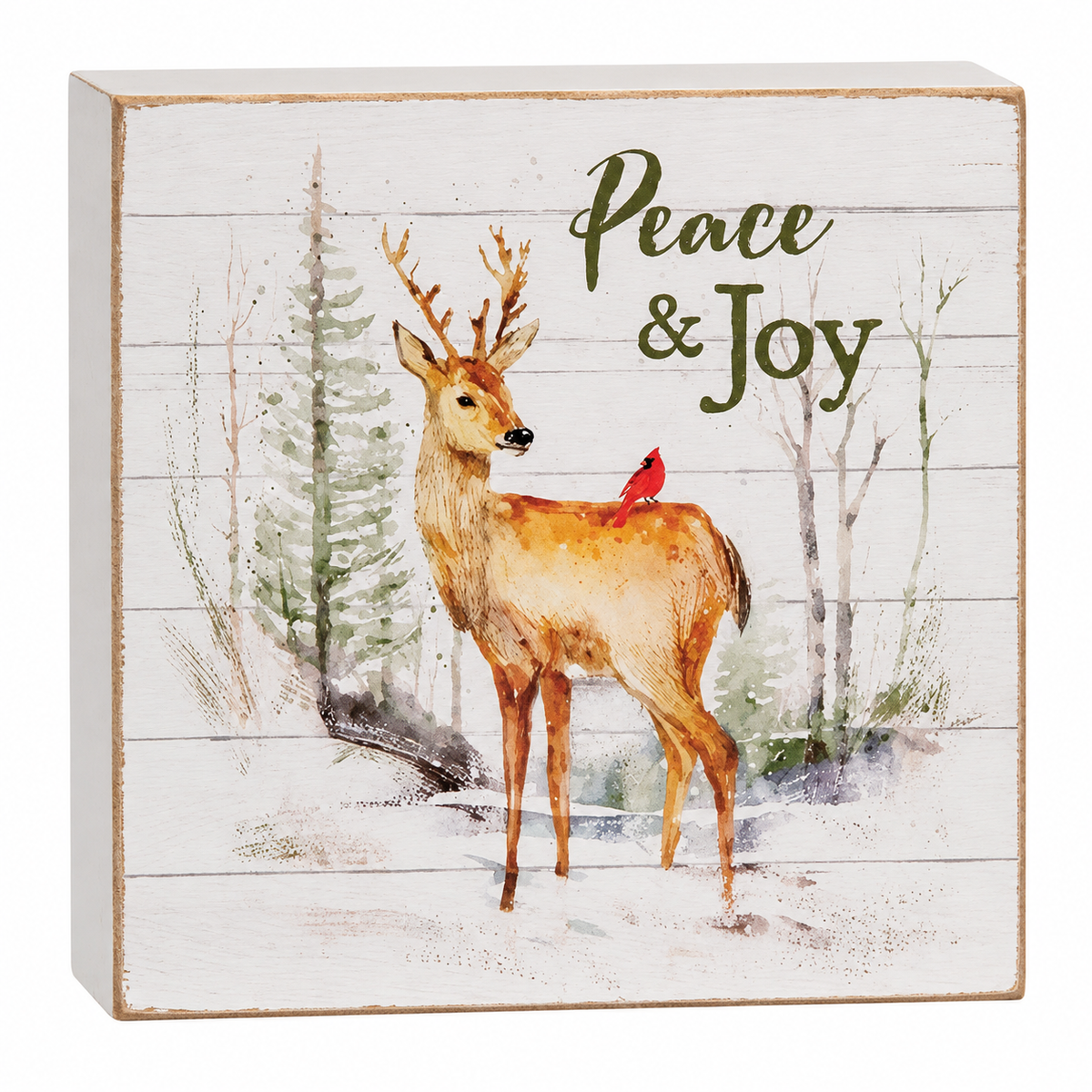 Square decorative wall sign with a watercolor-style deer standing in a snowy winter scene, a small red bird on the deer's back, and the words 'Peace & Joy' on a distressed white wood plank background.