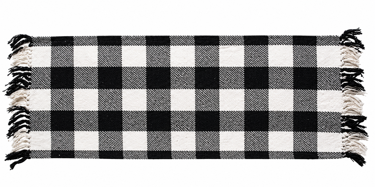 A black and white buffalo plaid throw blanket with fringed edges, shown flat against a white background.