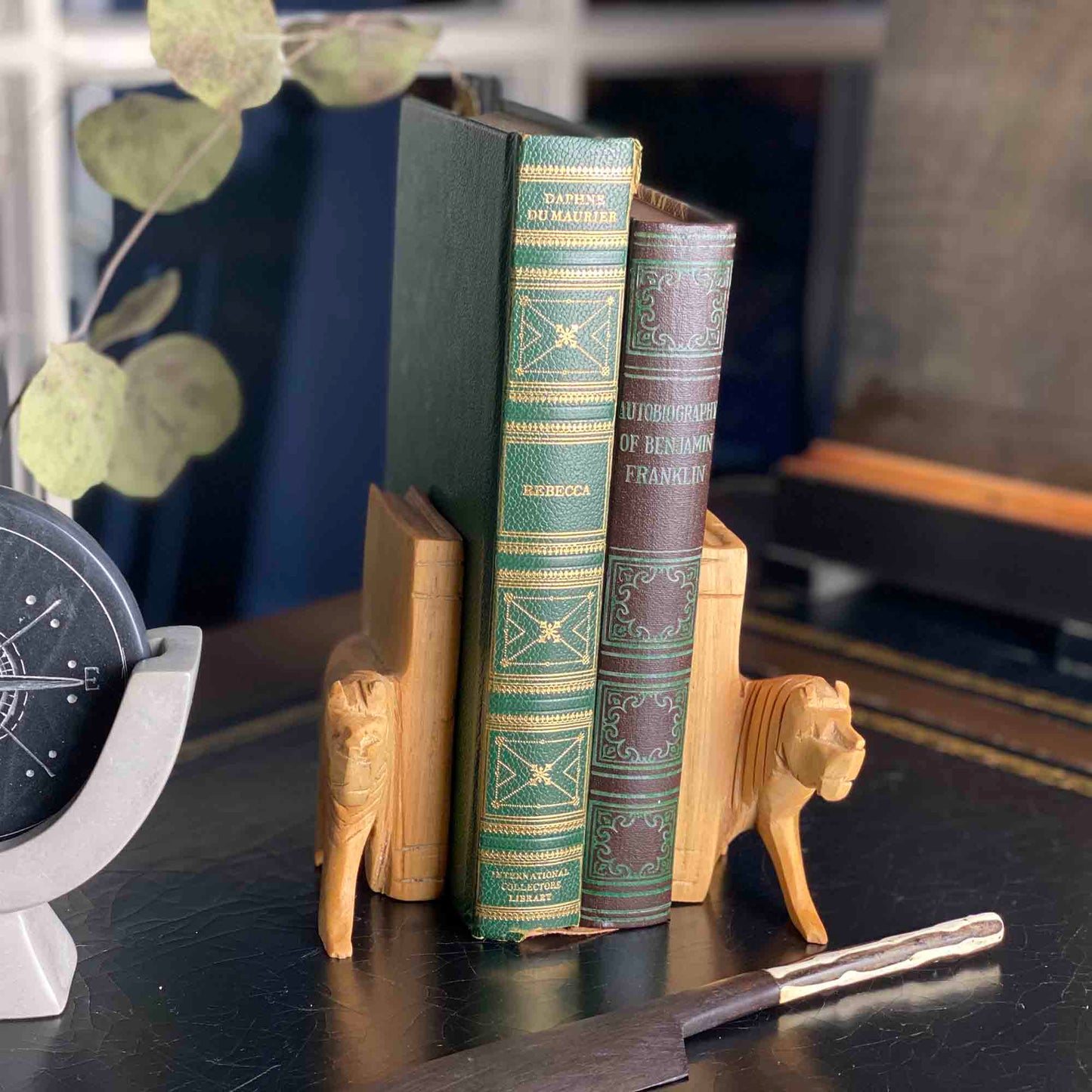 Artisan-carved bookends shaped like lions from Kenya