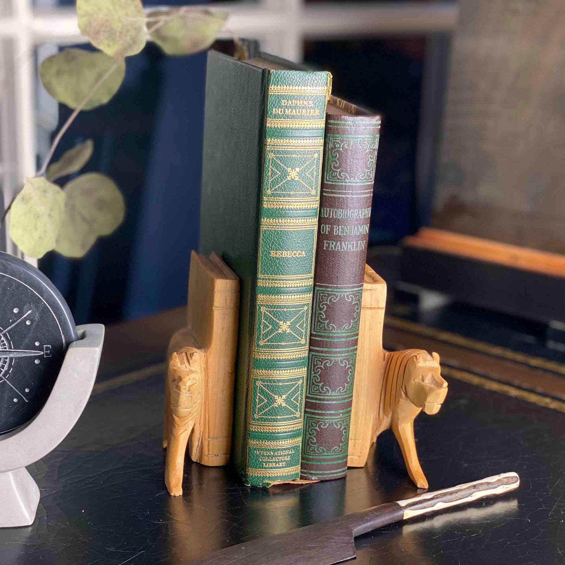 Artisan-carved bookends shaped like lions from Kenya