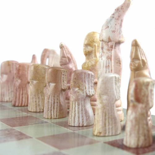 Close-up of soapstone chess pieces with smooth, polished detailing, individually shaped by skilled carvers.