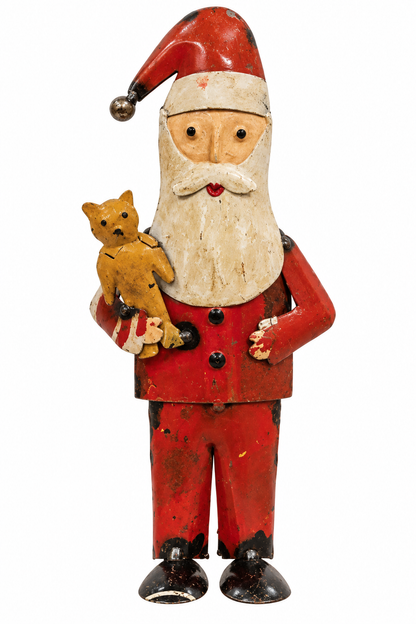 Vintage hand-painted tin Santa Claus figurine holding a small teddy bear, shown against a plain white background.