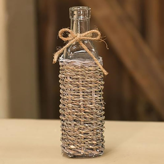 Decorative glass bottle wrapped in seagrass and whitewashed reeds with a burlap bow, rustic home accent for coastal or farmhouse décor