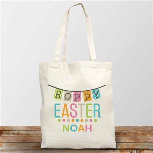 Festive Easter-themed cotton tote bag customized with child's name, vibrant colors, and cheerful bunny-inspired graphics, perfect for carrying Easter treats or gifts.