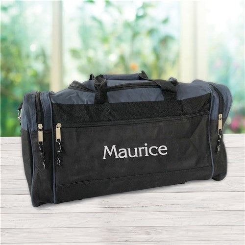 Custom embroidered travel bag with zippered compartments and detachable strap